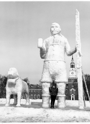 Swiss man and his dog with skis, lederhosen, and a beer stein