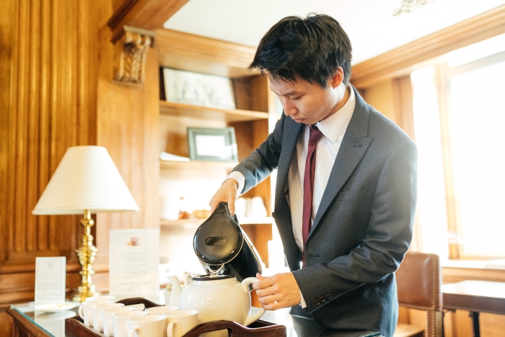 Herbert Chang serves tea at Sanborn Library.