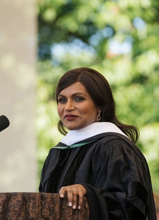 Mindy Kaling speaking at the podium.