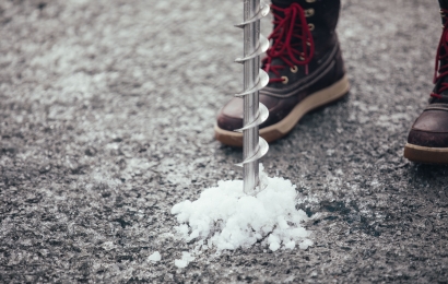 A large drill bit being used to drill into the permafrost on the ice sheet.