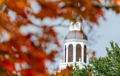 Red leaves framing Baker Tower