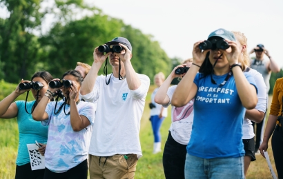 Students looking through binoculars