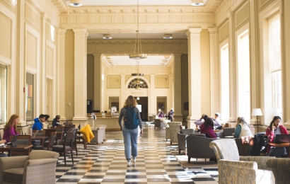 Students walking and studying in Reiss Hall in Baker Library