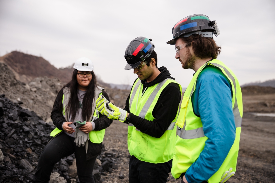 Students and trip leader take a closer look at some coal.