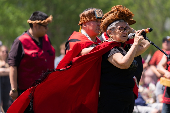 Gitxaała matriarch Margaret Hill speaks wearing headdress.