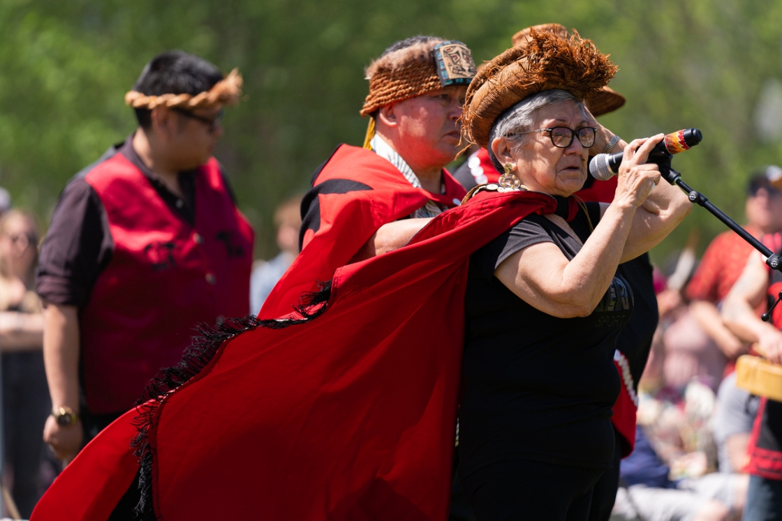 Gitxaała matriarch Margaret Hill speaks wearing headdress.