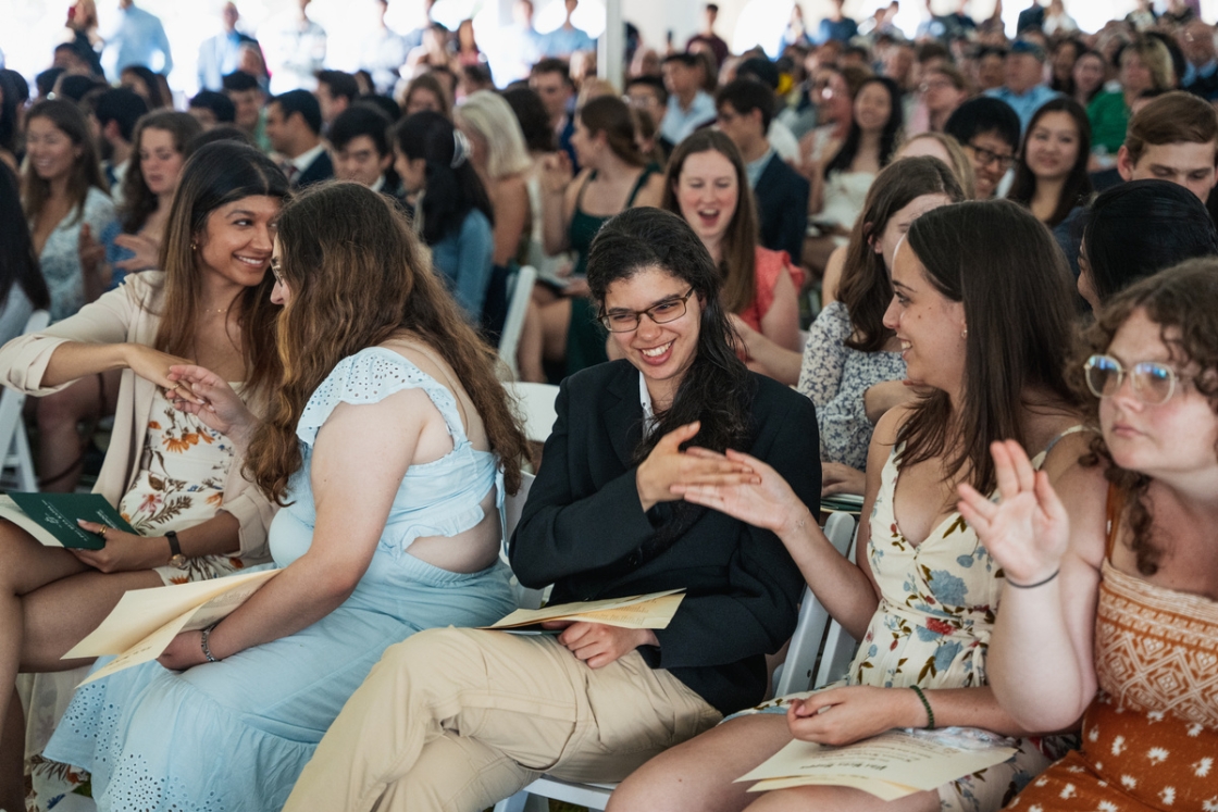 Graduates performing secret handshakes at Phi Beta Kappa ceremony