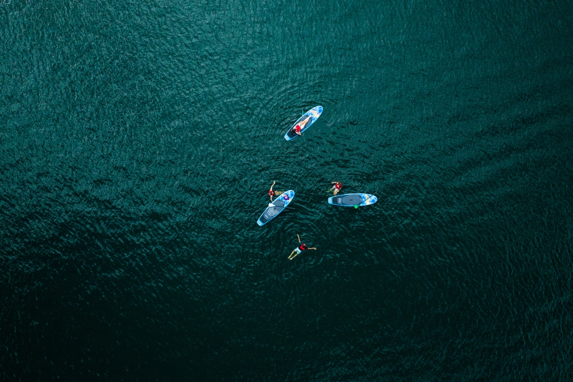 Students paddleboard on a DOC trip