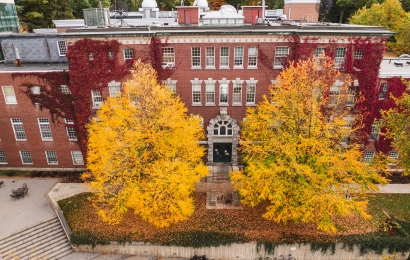 Wilder Hall framed by bright yellow trees and rich red ivy