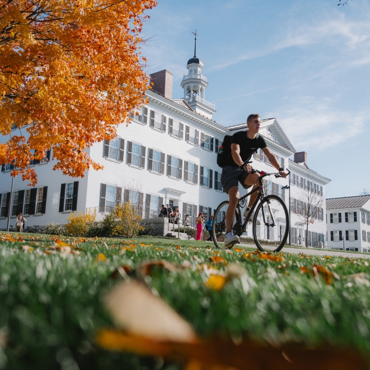 Student rides bike past Dartmouth Hall