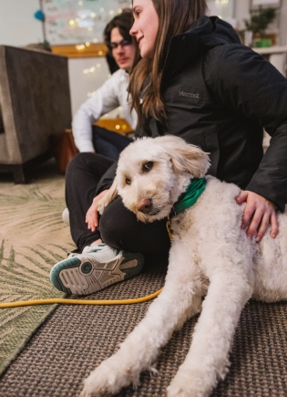 Katharyn Hammerness sits with a dog