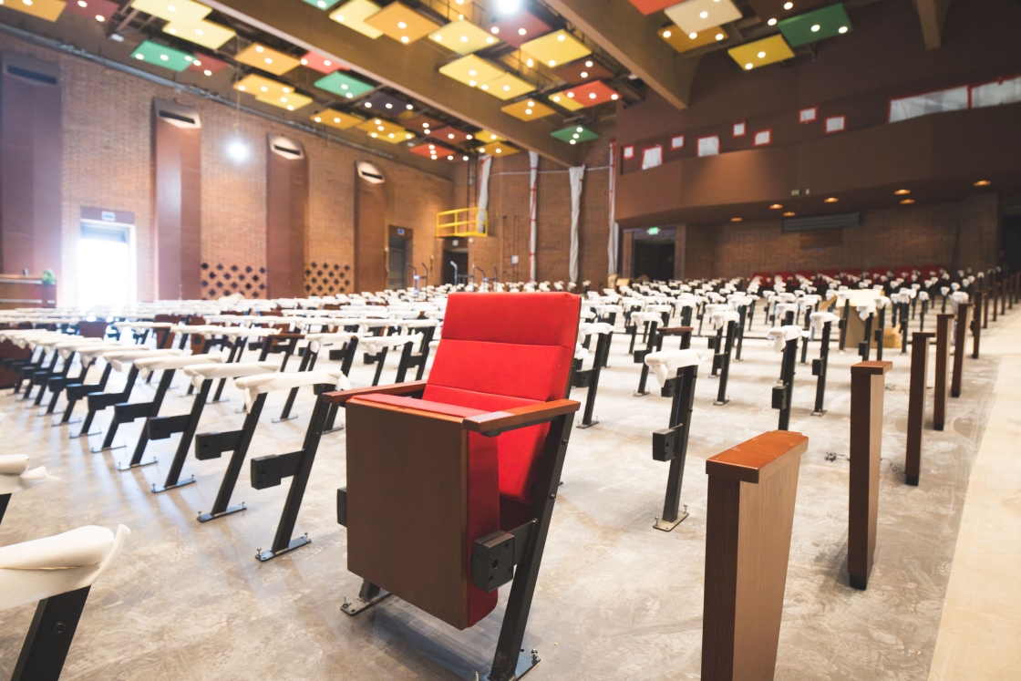 Single red auditorium seat in Spaulding