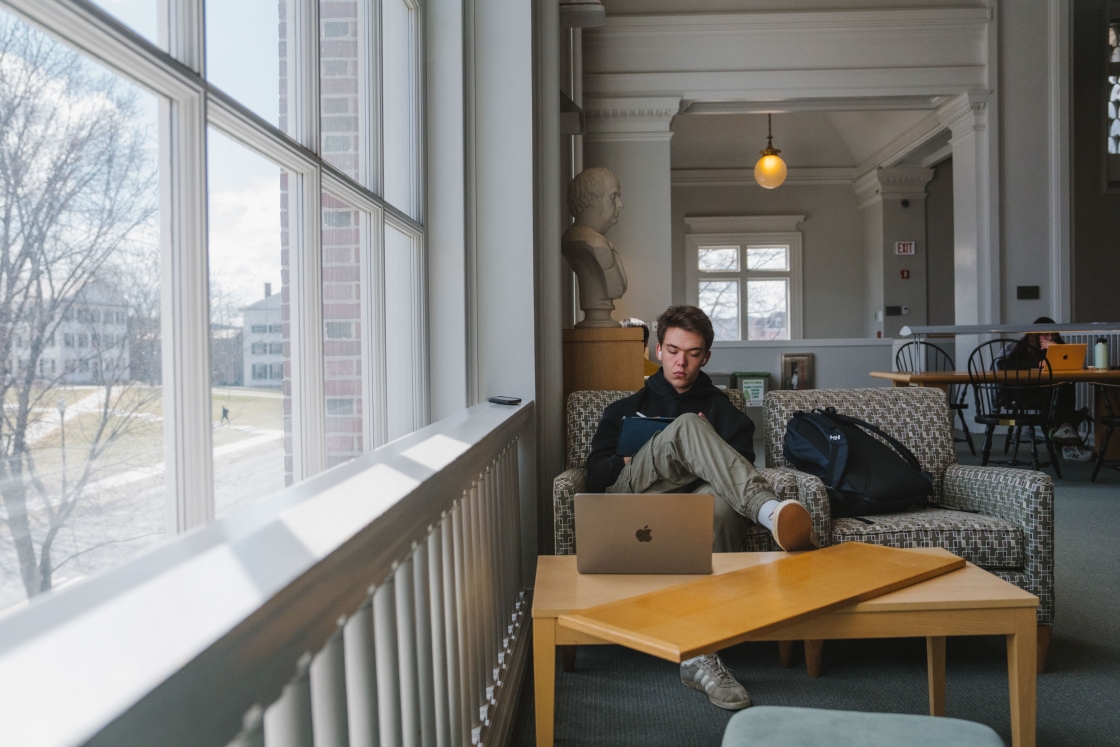Ben Merrett on a couch in the library