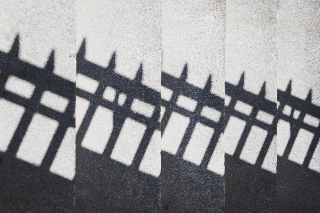 Fence shadow on stone steps