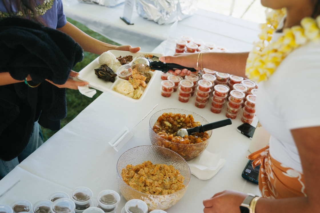 Food being served onto a Styrofoam tray