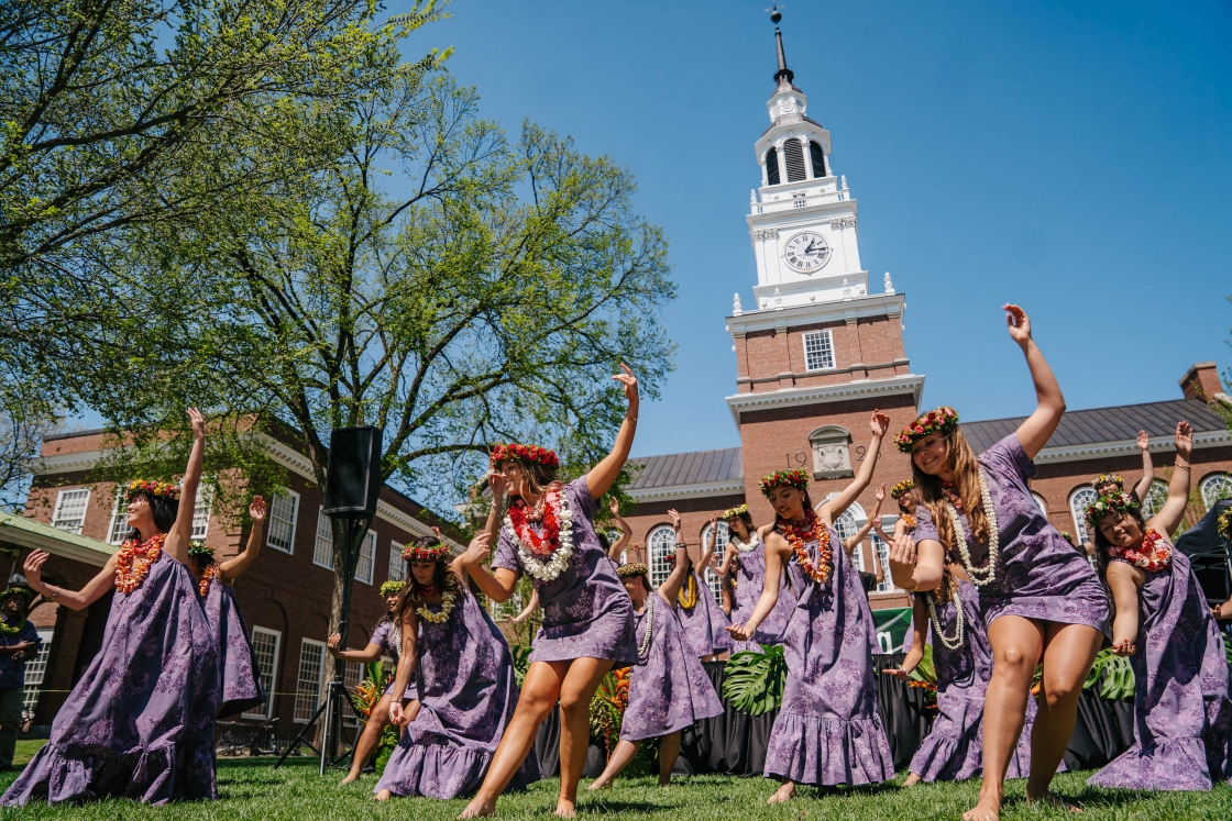 Students dance in front of Baker Tower in festive apparel
