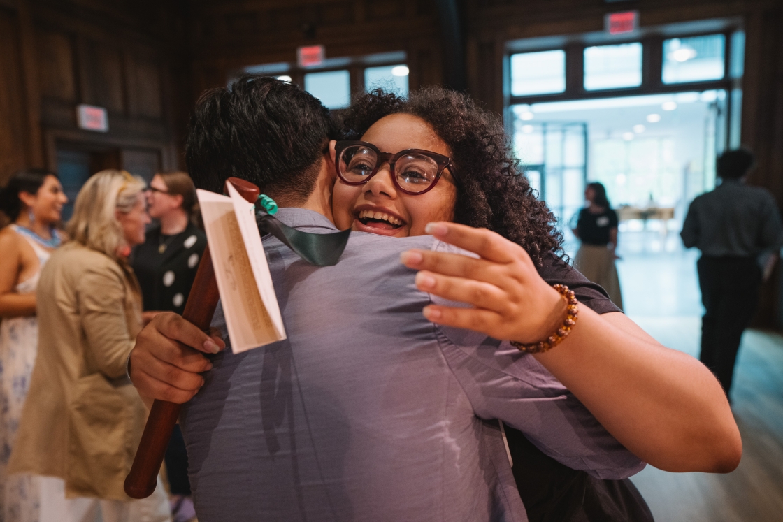 Esmeralda Jerez hugging someone with an award in hand