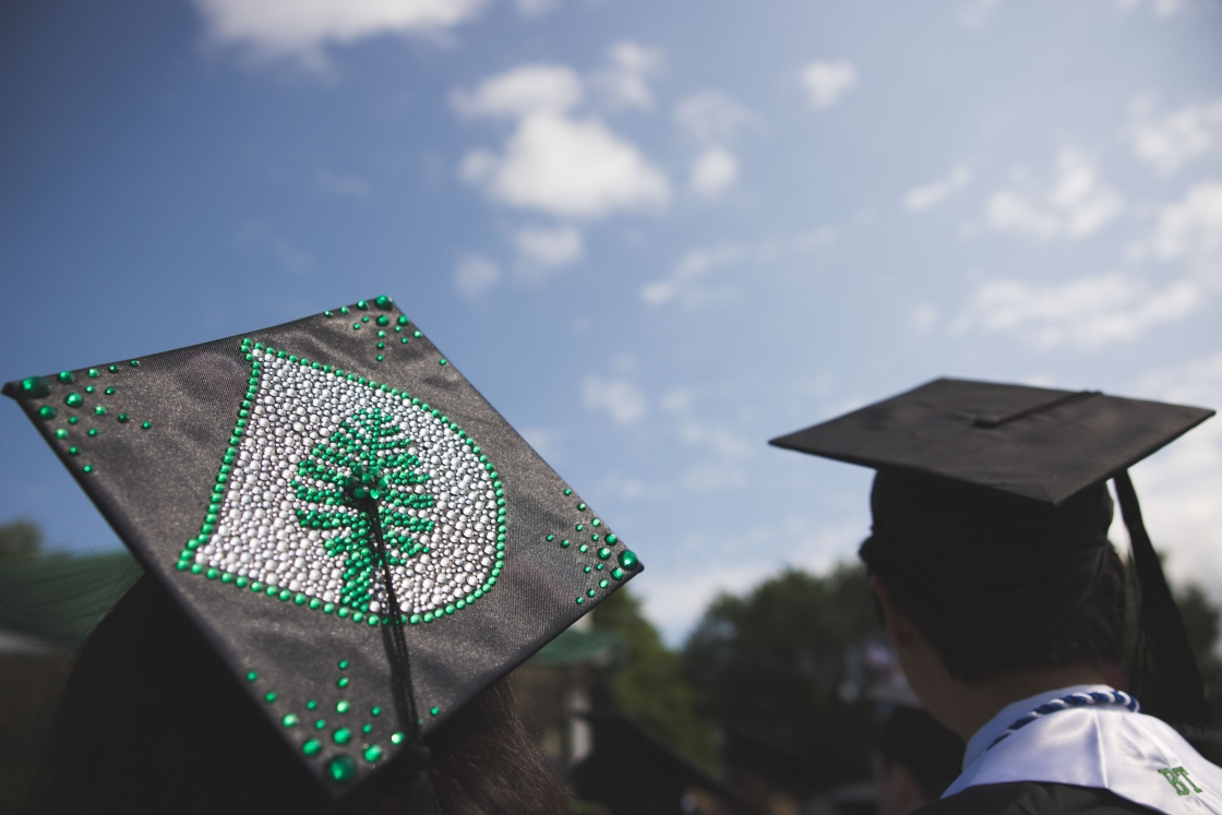 A mortar board bedazzled with the D-pine logo