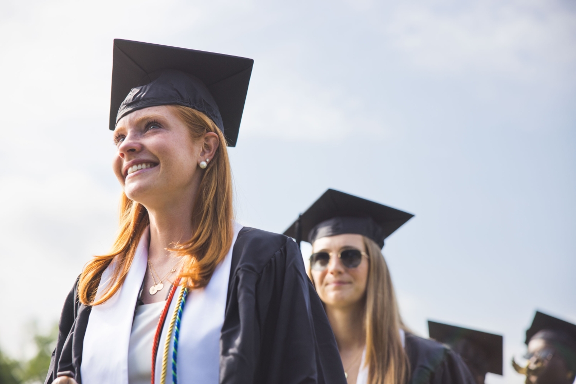 A graduate smiles with tears in her eyes