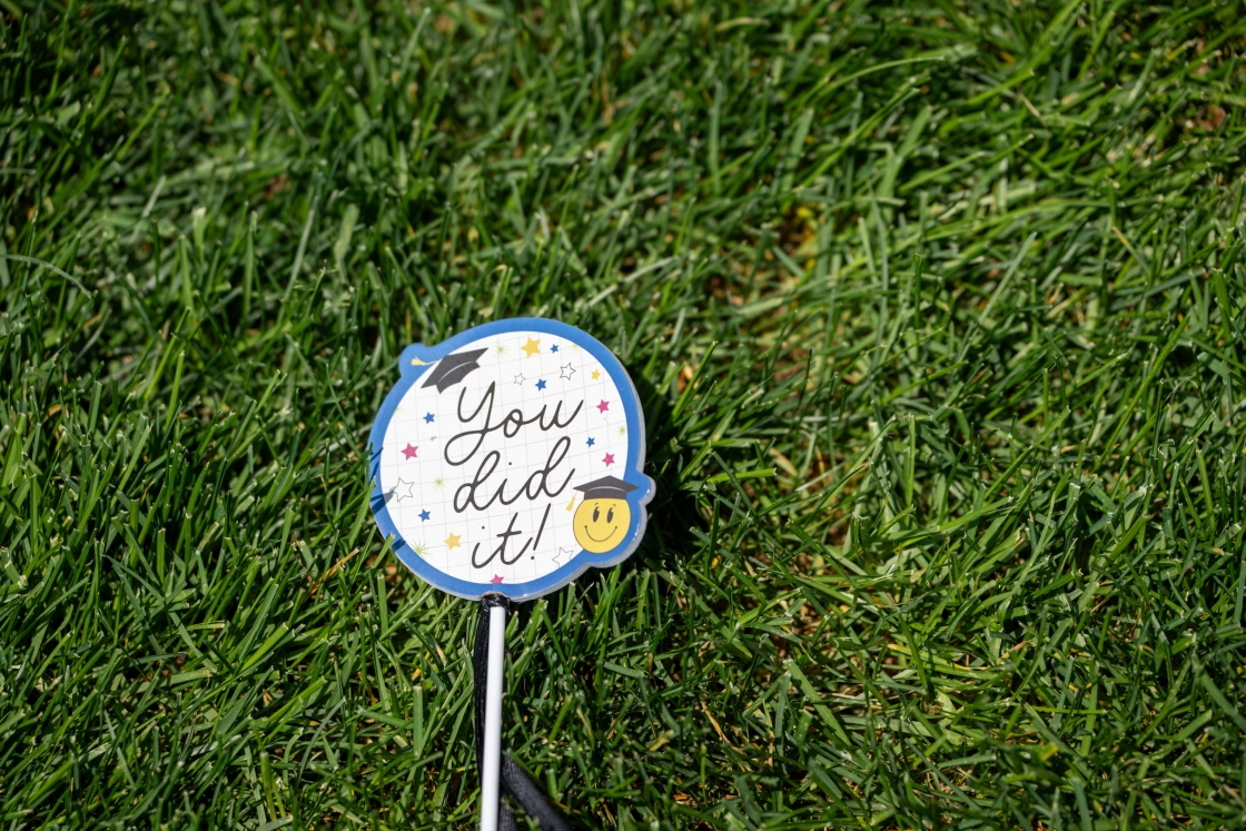 A sign in the grass that reads &quot;You did it!&quot;