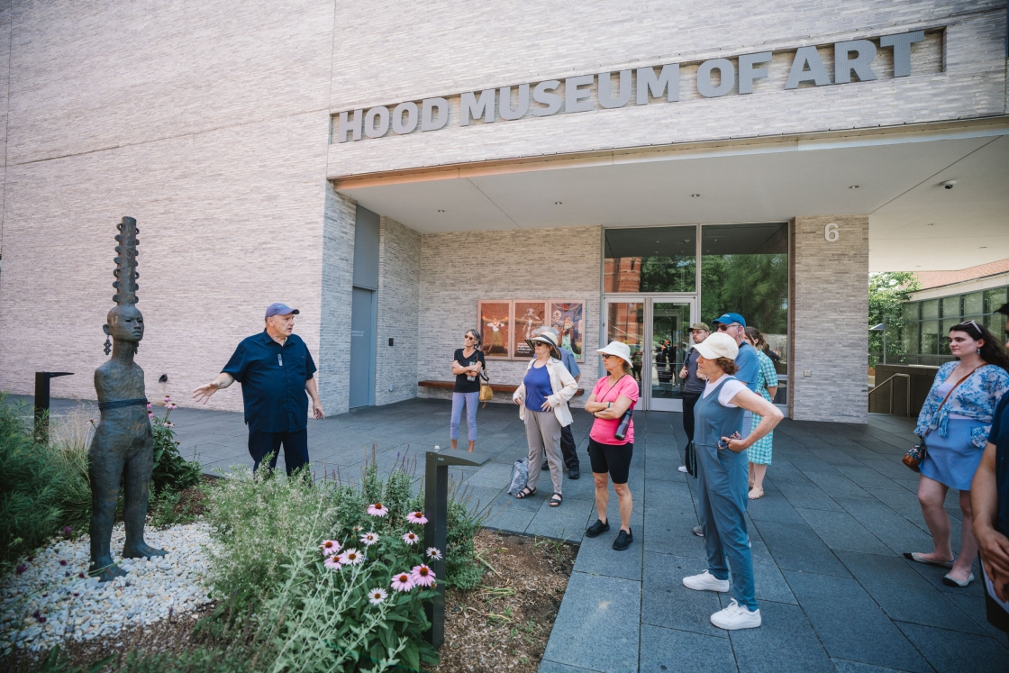 John Stomberg shows a statue to a walking group