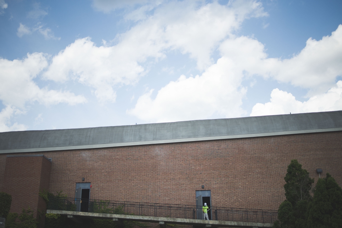 Person paints the doors at Spaulding Auditorium