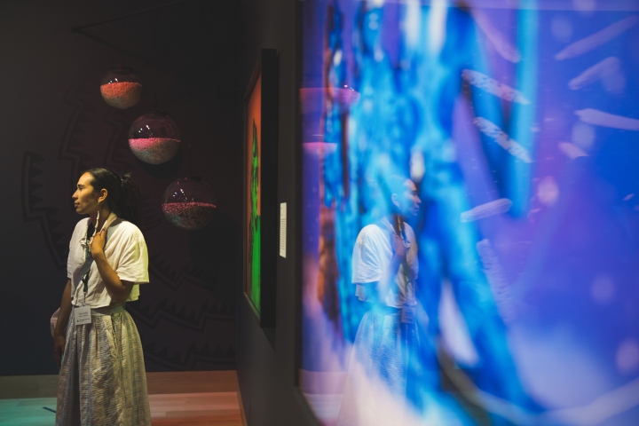 Person stands in front of blue colored art