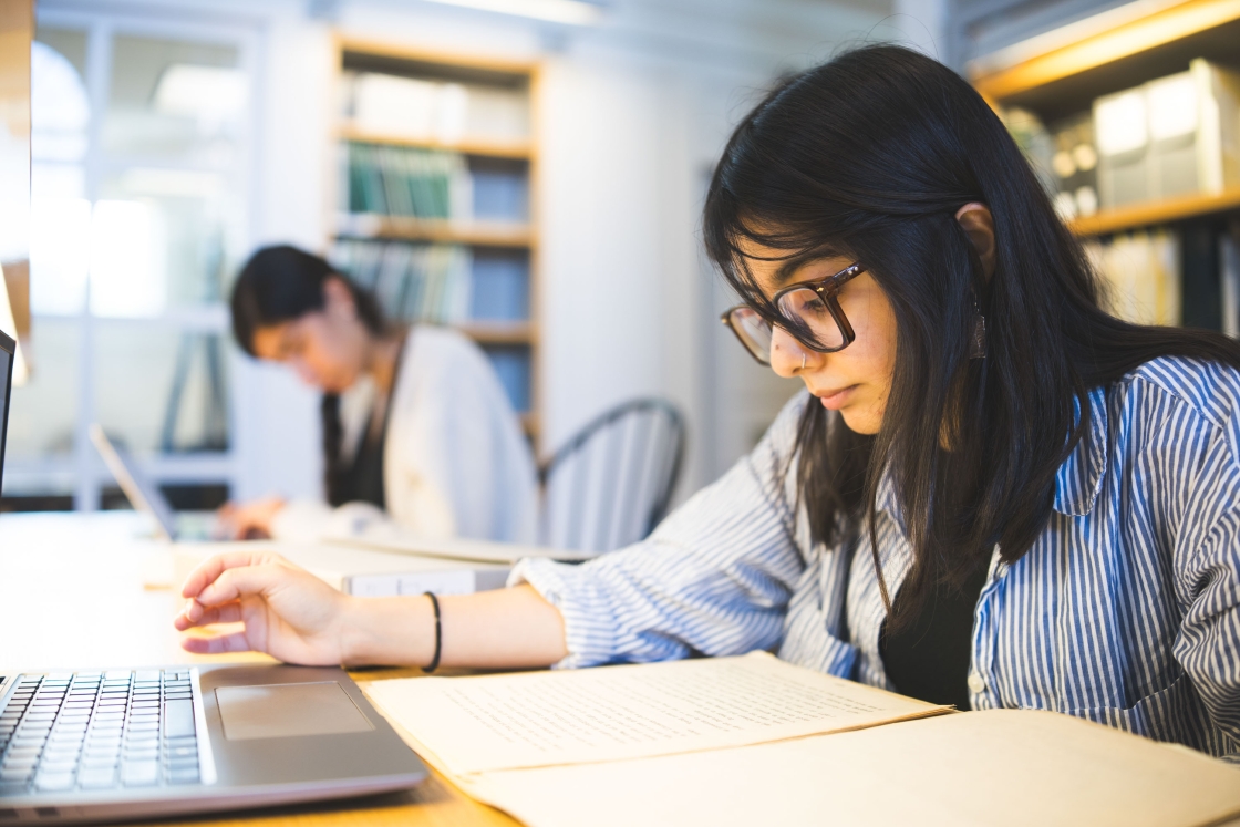 Maya Razvi reading papers