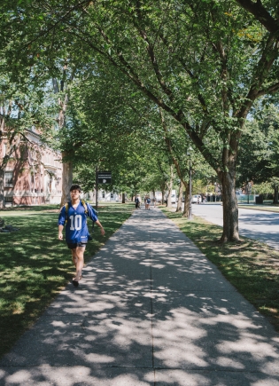 Student walks down the sidewalk