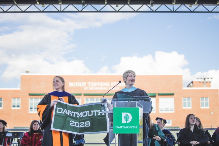 Nina Pavcnik and Kathryn Bezella at a podium