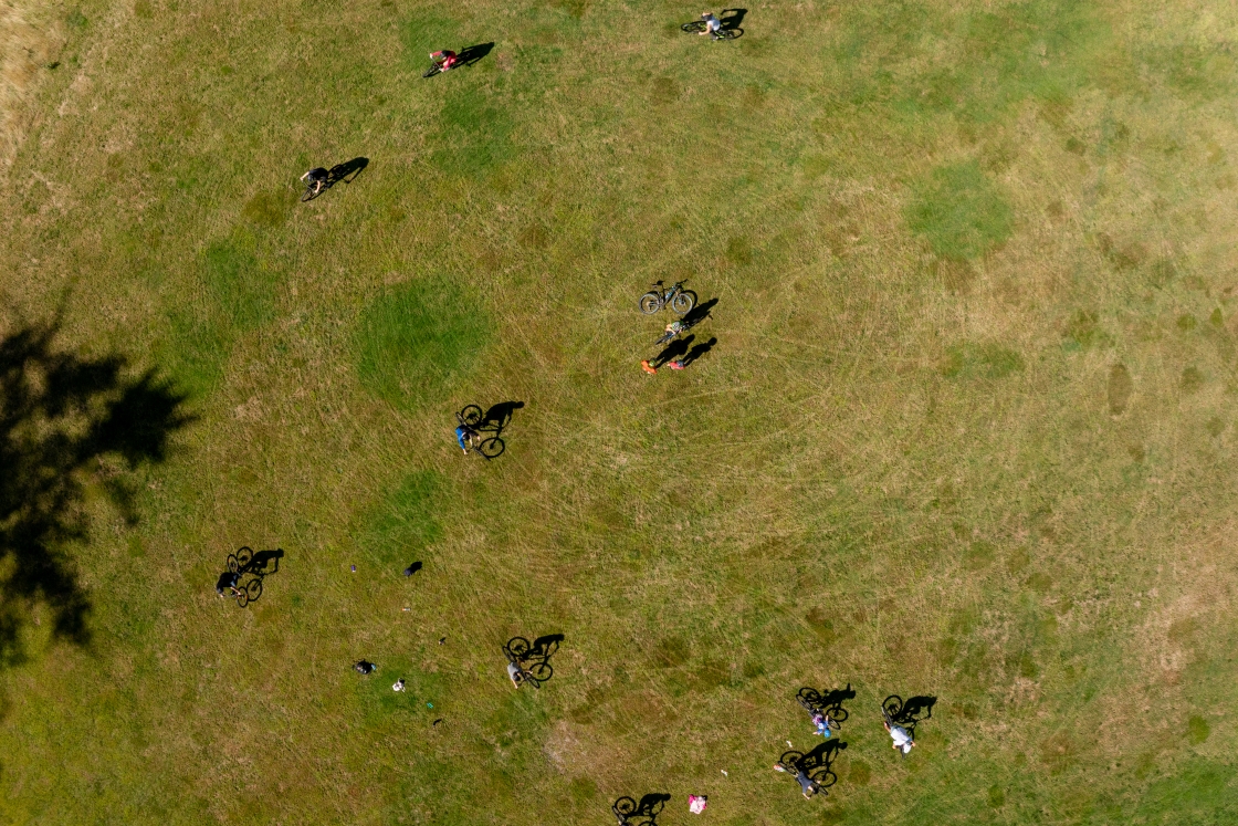 An aerial view of students circling on mountain bikes