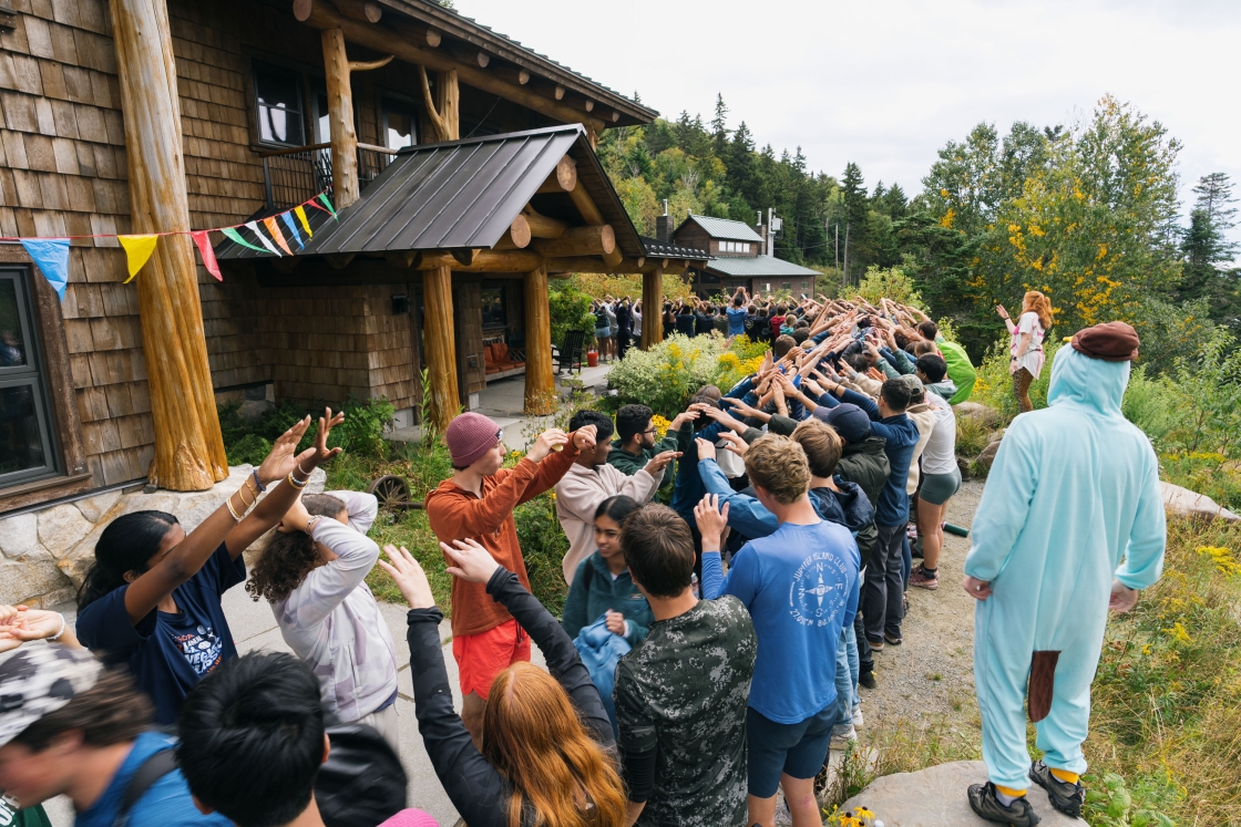 Students walk through a tunnel of people