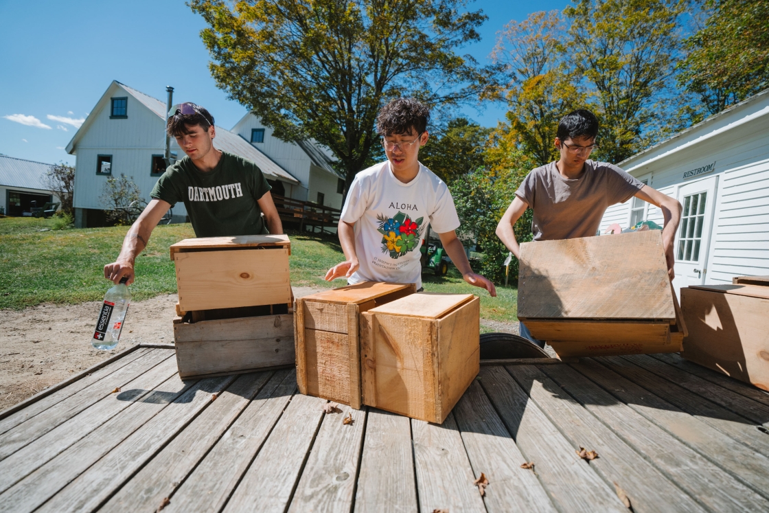 Students unloading wooden crates