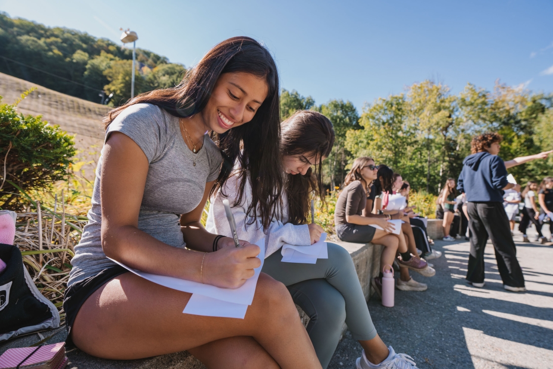 Rohini Kieffer and Zeine Nabulsi writing letters