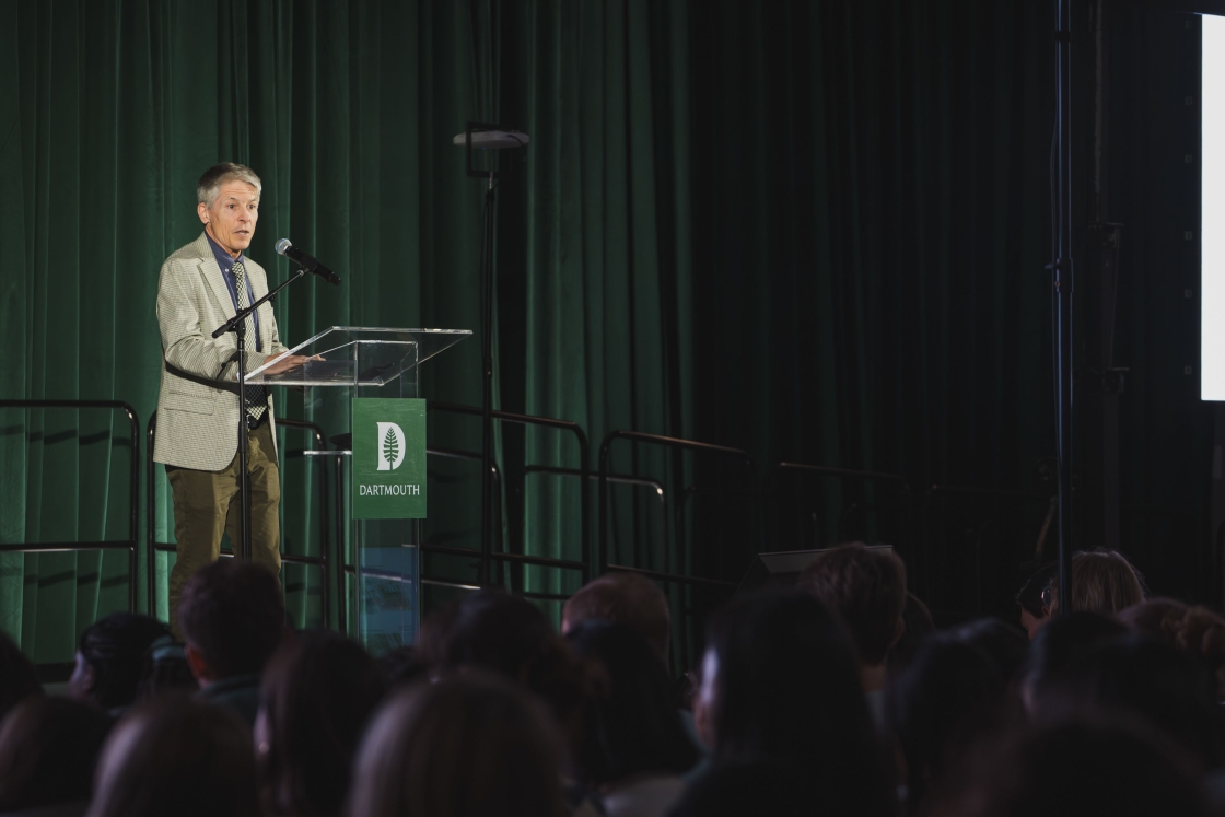 John Carey behind a podium