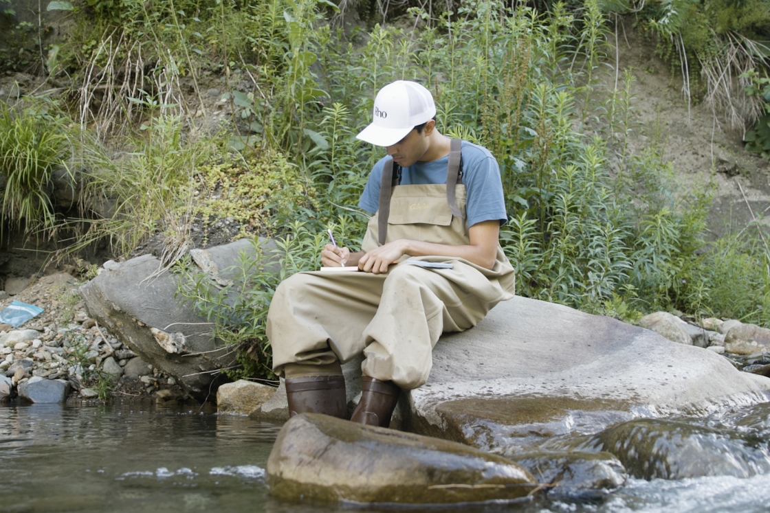 Student sitting with their feet in water
