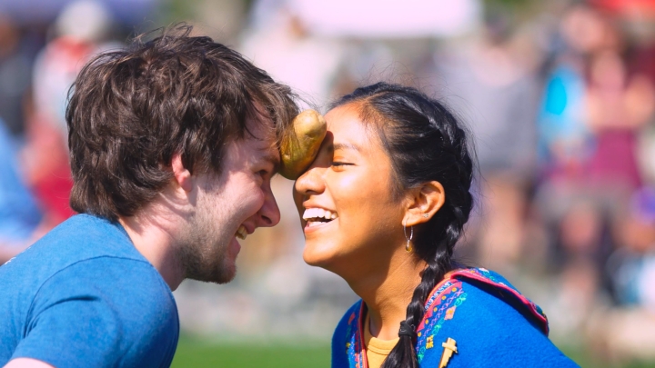 Students hold a potato between their foreheads