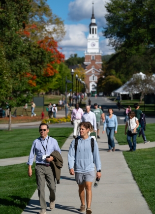 People walking away from Baker Tower