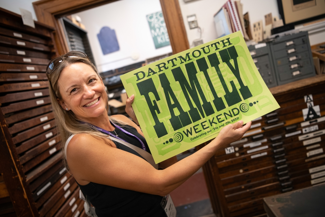 Person holding Family Weekend poster