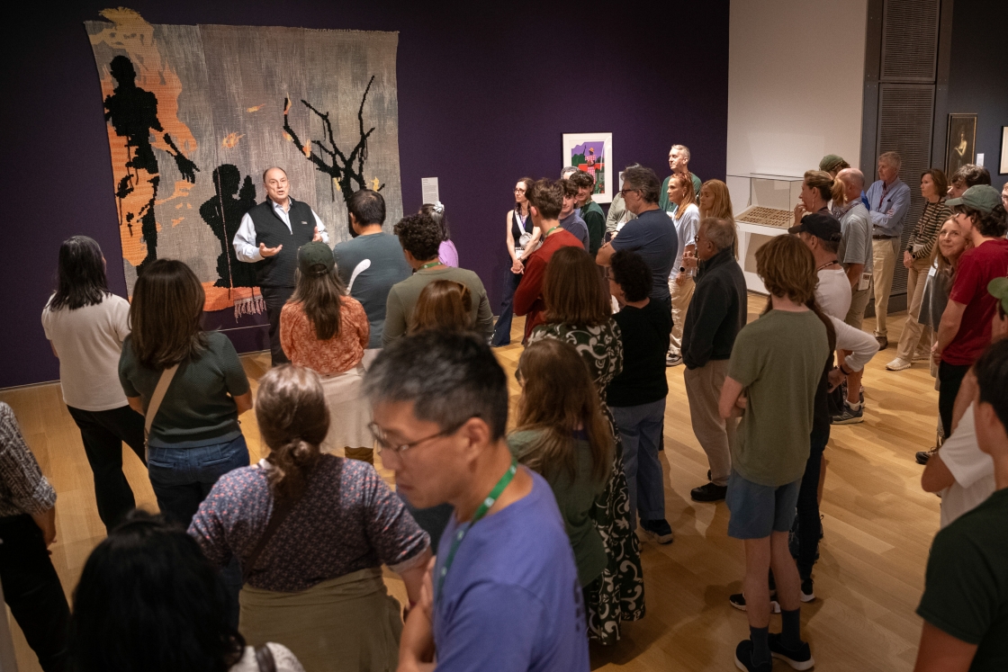 Families browsing art in the Hood