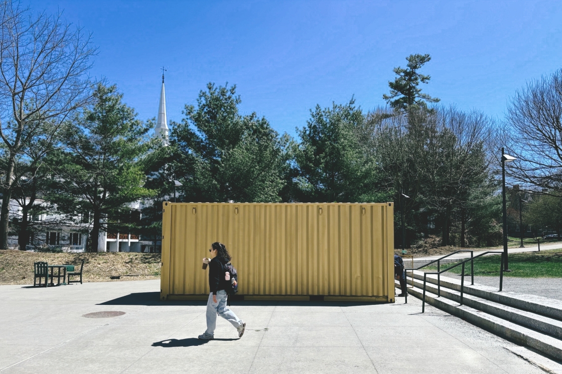 Student walks by shipping container