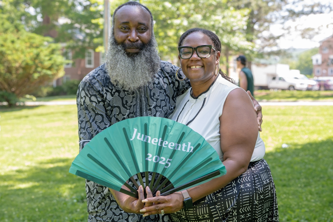 Adedoyin Teriba and Shontay Delalue holding a hand fan