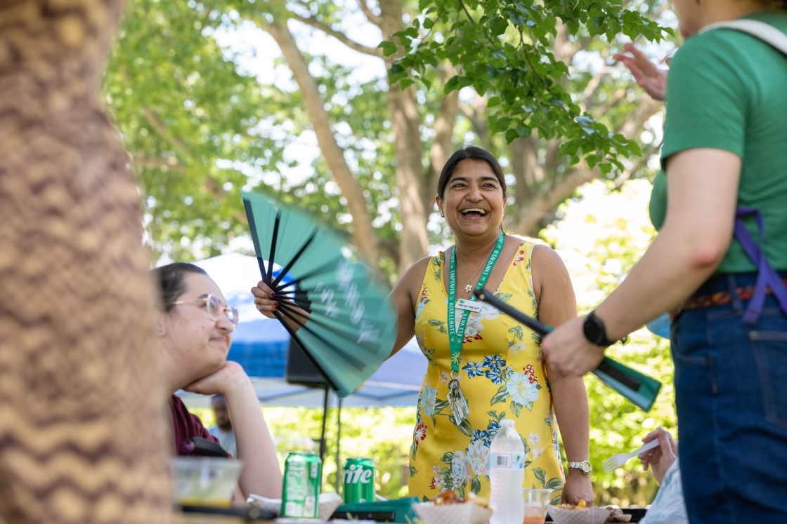Lilly Linden using a folding fan