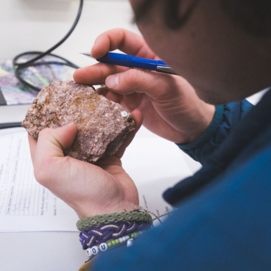 Student inspecting a rock sample