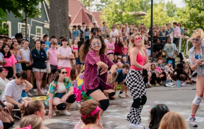 Students dancing in bright colored clothing
