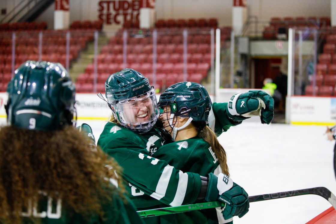 Two women's hockey players hugging